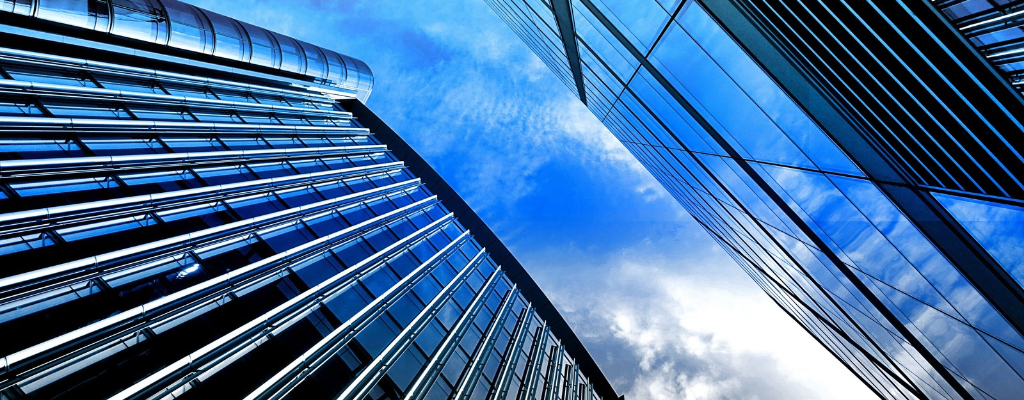 An image of large skyscrapers looking up from ground-level